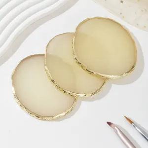 Detailed view of three-piece set cream resin nail art palettes with irregular gold edges