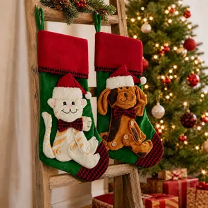 Macro detail of large Christmas stocking with 3D cat and dog embroidery on green velvet