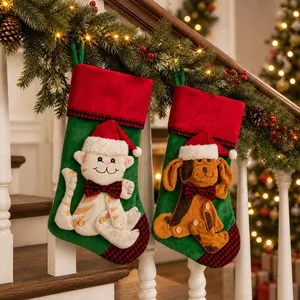Detail of pet themed Christmas stockings with cat and dog motifs on a lit staircase