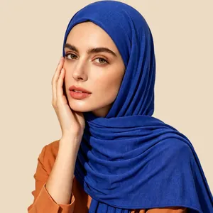 Detail of royal blue muslin hijab showing soft cotton texture and drape on a model