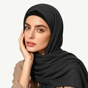 Detail of dark charcoal jersey hijab scarf with black undercap showing fabric texture