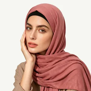 Close-up of elegant dusty rose ethnic style hijab with textured fabric and black inner band