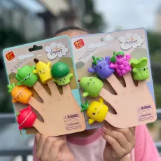 Close-up of fruit and vegetable finger puppets including broccoli and banana in packaging