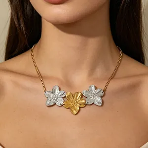 Elegant necklace with gold and silver flower pendants worn on neck for a stylish look