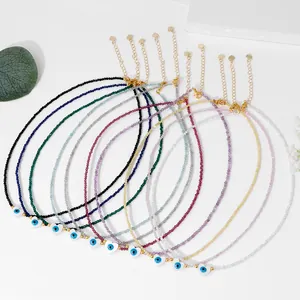 Macro view of eight colorful 2mm crystal bead necklaces with heart evil eye charms