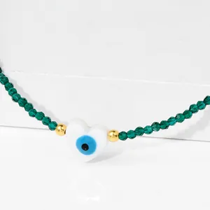 Green crystal bead necklace with evil eye heart charm and golden accents for women