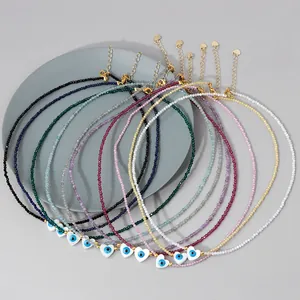 Detailed view of colorful 2mm crystal bead necklaces with evil eye heart pendants
