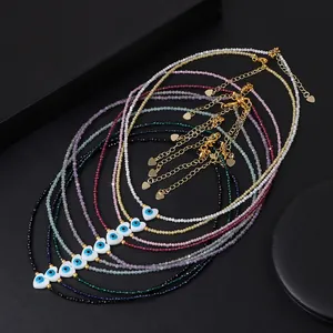 Macro shot of colorful beaded necklaces with evil eye heart charms and gold clasps