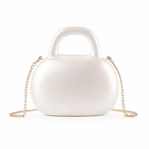 Chic pearlescent white acrylic evening handbag with a gold chain strap and curved handle