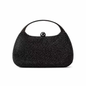 Close-up of black beaded evening clutch featuring polished metal handle and sphere clasp