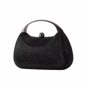 Detailed view of the luxury black beaded evening bag with a polished metal ring handle