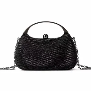 Detail of black beaded evening bag featuring moon shape and glossy metal top handle