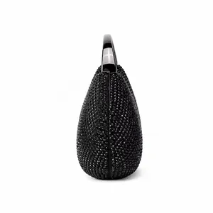 Close-up of teardrop evening bag featuring black rhinestones and a polished handle