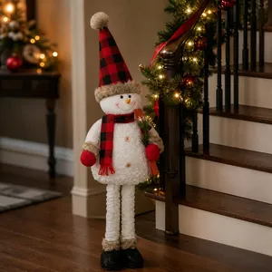 Standing Christmas snowman ornament with red buffalo plaid hat and scarf on stairs