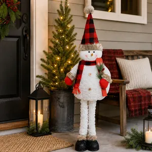 Standing Christmas snowman ornament with red and black buffalo plaid hat on cozy porch