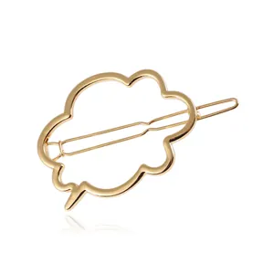 Detailed close-up of golden cloud-shaped hollow metal hair clip with polished finish