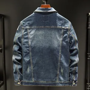 Rear view of slim fit dark blue denim jacket with washed texture and distressed details
