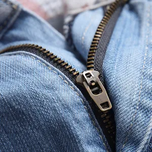 Men's blue denim shorts featuring a vintage bronze zipper and premium twill fabric details