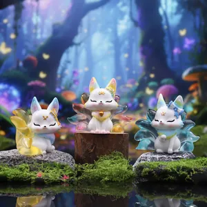 Three Nine-Tailed Fox collectible figurines with colorful gradient tails on moss