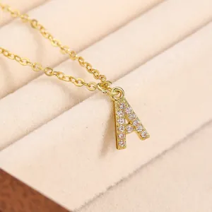 Macro shot of gold letter A pendant with sparkling cubic zirconia on soft velvet