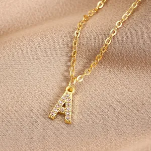 Macro view of gold initial A pendant with sparkling cubic zirconia on a delicate chain