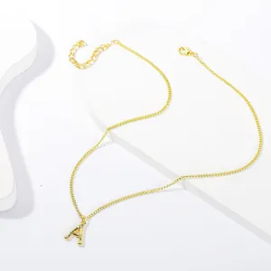 Detail of gold letter A pendant with bamboo texture and adjustable chain clasp