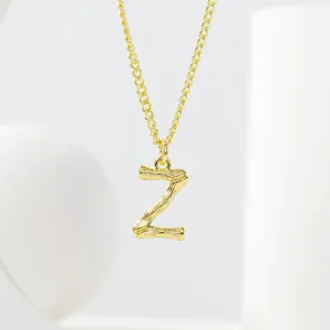 Close-up of golden letter Z pendant with bamboo texture on a delicate cable chain