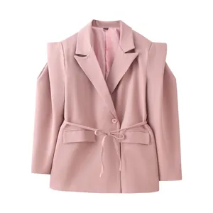 Detail of pink cold shoulder blazer showing structured lapel and waist tie belt