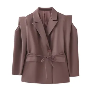 Detail of waist-belted mauve blazer with unique padded cape-shoulder layering