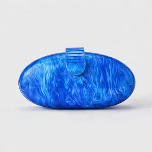 Macro view of blue marble acrylic evening clutch with luxury shell texture and clasp