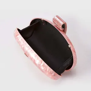 Detailed interior of the pink marble acrylic shell clutch with black fabric lining