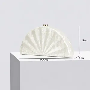 Detail showing dimensions of marble texture half-moon evening clutch bag with gold clasp