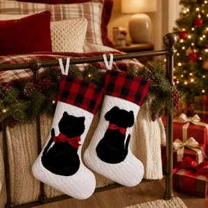 Detail of red and black plaid pet Christmas stockings with cat and dog silhouettes