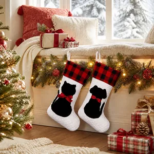 Close-up of quilted pet Christmas stockings with cat and dog silhouettes on a mantle