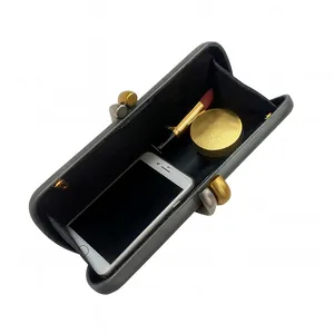 Top view of dark grey evening clutch showing interior storage for phone and lipstick