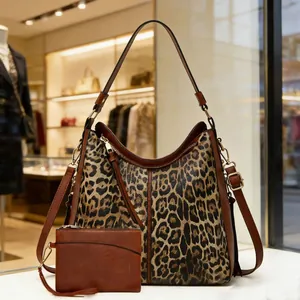 Macro shot of hobo bag set with leopard print texture and matching mini pouch