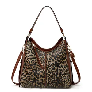 Detail view of vintage brown leather hobo bag featuring leopard print and gold zipper