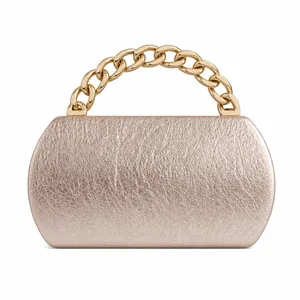 Detailed view of champagne gold evening clutch with crinkled texture and chunky chain