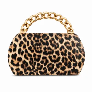Detail of the leopard print PU leather bag featuring a bold gold chunky metal chain handle