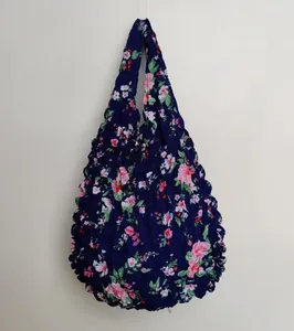 Close-up of dark blue floral pleated magic bag with expandable bubble fabric texture