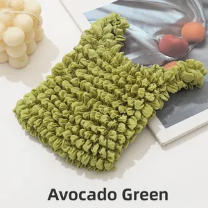 Close-up of grass green bubble textured tote bag with aesthetic lifestyle props
