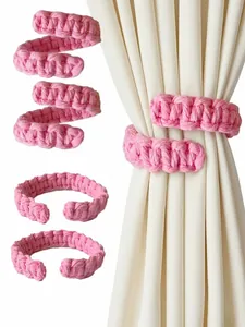 Detailed pink cotton rope curtain tieback with woven texture and spiral design