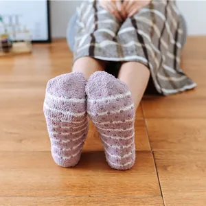 Women's purple striped plush floor socks with non-slip silicone grips on the sole