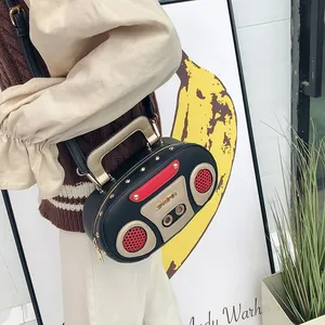 Detail of vintage radio-shaped crossbody bag worn with retro pop art background