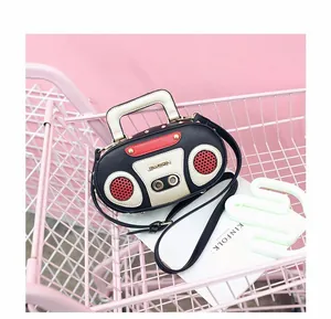 Close-up of retro boombox handbag in a pink shopping cart with stylish metal rivets