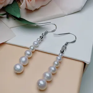 Detailed macro shot of S925 sterling silver hooks and gradient white freshwater pearls