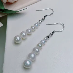 Macro view of S925 silver hook and gradient natural freshwater pearl drop earrings