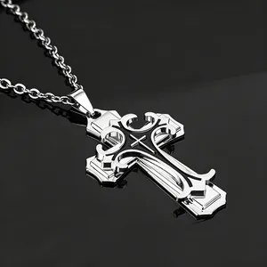 Vue macro d'un pendentif croix argenté à trois couches avec détails en émail noir