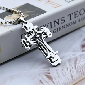 Vue macro du pendentif croix en argent avec émail noir et chaîne à billes en métal