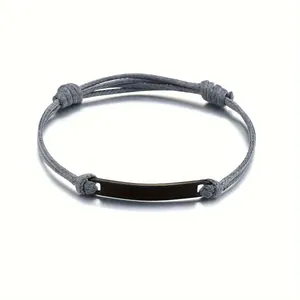 Detail of minimalist woven grey cord bracelet with polished black stainless steel plate